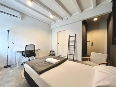 a bedroom with a bed and a desk and a chair at Chatel Samyan - Self check-in in Bang Rak
