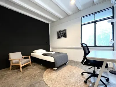 a bedroom with a bed and a desk and a table at Chatel Samyan - Self check-in in Bang Rak