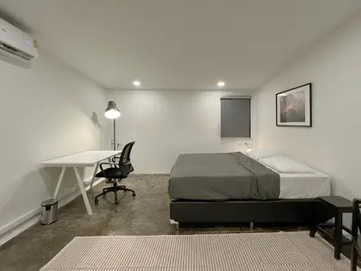 a bedroom with a bed and a desk and a table at Chatel Samyan - Self check-in in Bang Rak
