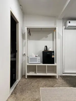 a room with a white shelf with a microwave at Chatel Samyan - Self check-in in Bang Rak