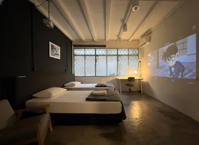 a bedroom with two beds and a tv on the wall at Chatel Samyan - Self check-in in Bang Rak