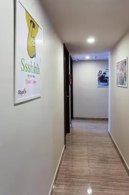 a hallway with a white wall with a sign on it at Studio Nana by iCheck inn in Bangkok