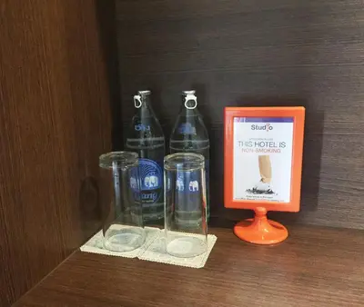 two bottles and a picture next to a picture of a bottle at Studio Nana by iCheck inn in Bangkok