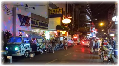 a busy city street at night with people and cars at Studio Nana by iCheck inn in Bangkok