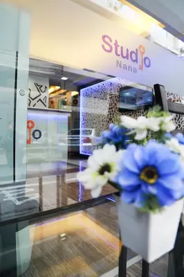 a vase of blue and white flowers in a store at Studio Nana by iCheck inn in Bangkok