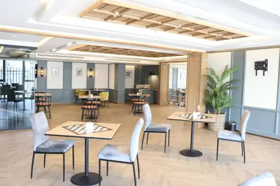 a restaurant with tables and chairs in a room at The Quart Ruamrudee by UHG in Bangkok