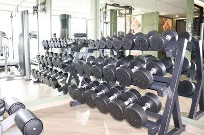 a row of dumbbells in a gym at The Quart Ruamrudee by UHG in Bangkok