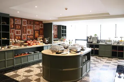 a large kitchen with a island in the middle at The Quart Ruamrudee by UHG in Bangkok