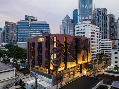 a building in a city with tall buildings at The Quart Ruamrudee by UHG in Bangkok
