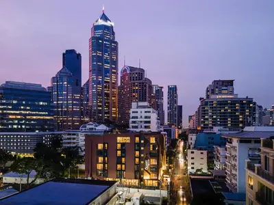 a view of a city skyline at night at The Quart Ruamrudee by UHG in Bangkok