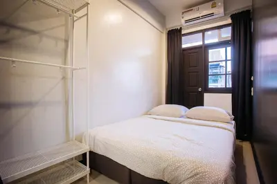 a small bedroom with a bed and a window at T3 TWO Bedrooms WIFI Full kitchen 1 min to BTS in Bangkok