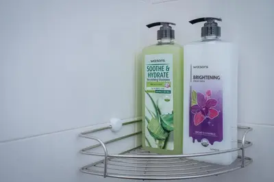 two bottles of soap on a shelf in a bathroom at T3 TWO Bedrooms WIFI Full kitchen 1 min to BTS in Bangkok