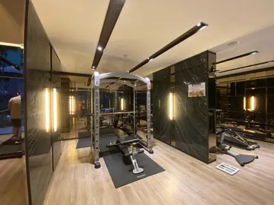 a gym with treadmills and ellipticals in a building at Politan Breeze, Chaophraya River view in Ban Sai Ma