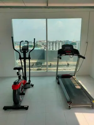 two exercise bikes in a room with a window at PRL Place in Bangkok