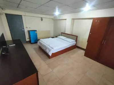 a bedroom with a bed and a desk in it at PRL Place in Bangkok