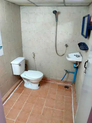 a bathroom with a toilet and a sink at PRL Place in Bangkok