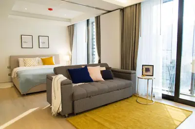 a living room with a couch and a bed at Sukhumvit 11#Luxury#Pool#Gym#BTS Nana&MRT Sukhumvit#1BR#Max4ppl in Bangkok