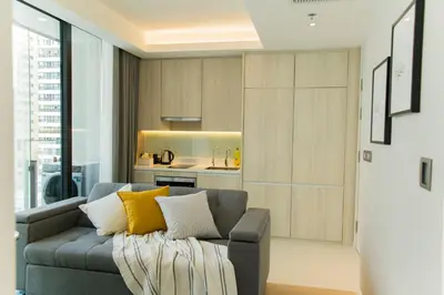 a living room with a gray couch with yellow pillows at Sukhumvit 11#Luxury#Pool#Gym#BTS Nana&MRT Sukhumvit#1BR#Max4ppl in Bangkok