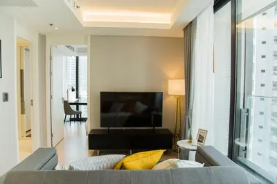 a living room with a couch and a television at Sukhumvit 11#Luxury#Pool#Gym#BTS Nana&MRT Sukhumvit#1BR#Max4ppl in Bangkok