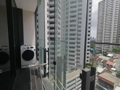 a balcony with a view of a city with tall buildings at Sukhumvit 11#Luxury#Pool#Gym#BTS Nana&MRT Sukhumvit#1BR#Max4ppl in Bangkok