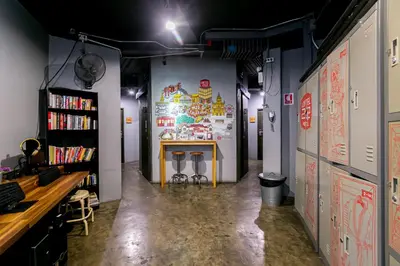 a room with a table in the middle of it at Loftel 22 Hostel in Bangkok