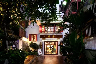 an entrance to a store at night at Photohostel in Bangkok