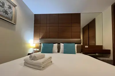 a bedroom with a bed with towels on it at Silom Forest Exclusive Residence in Bangkok