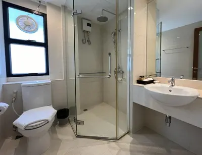 a bathroom with a shower and a toilet and a sink at Silom Forest Exclusive Residence in Bangkok