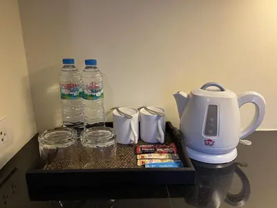 a tray with two bottles of water and drinking glasses at Silom Forest Exclusive Residence in Bangkok