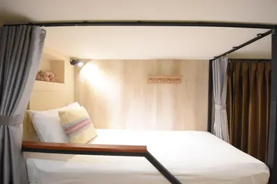 a bed with a canopy in a room at Silom Forest Exclusive Residence in Bangkok