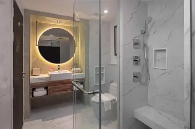 a bathroom with a shower and a toilet and a sink at Aira Hotel Bangkok Sukhumvit 11 in Bangkok