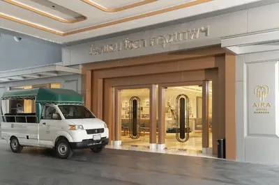 a white van parked in front of a store at Aira Hotel Bangkok Sukhumvit 11 in Bangkok