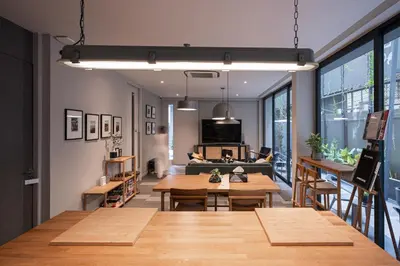 a living room with tables and a couch at humble abode Bangkok Vacation Home in Bangkok
