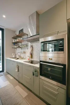 a kitchen with a sink and a stove at humble abode Bangkok Vacation Home in Bangkok