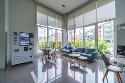 a living room with a couch and chairs and windows at Sabai Residence @Bangyai in Nonthaburi