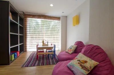 a living room with a purple couch and a table at iCheck inn Residences Sathorn in Bangkok