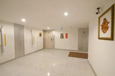 a hallway with white walls and a picture on the wall at iCheck inn Residences Sathorn in Bangkok