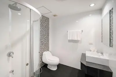 a white bathroom with a toilet and a sink at iCheck inn Residences Sathorn in Bangkok