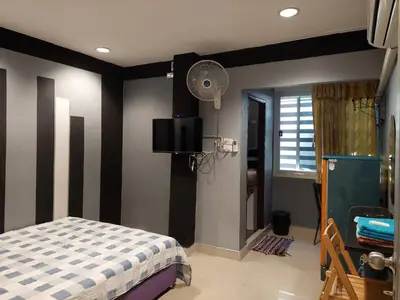a bedroom with a bed and a black and white striped wall at BB GuestHouse in Ban Zong Katiam