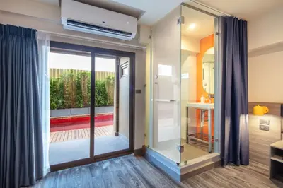 a room with a sliding glass door with a balcony at SureStay by Best Western Iconic Ari-Jatujak in Bangkok