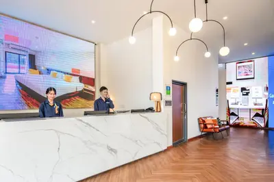 two people sitting at a counter in a lobby at SureStay by Best Western Iconic Ari-Jatujak in Bangkok