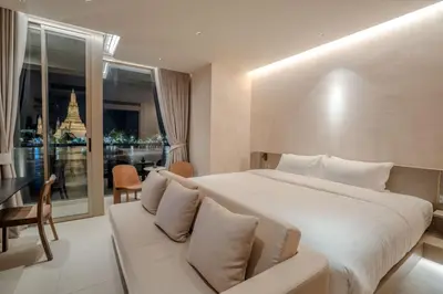a bedroom with a large bed and a couch at Inn a day in Bangkok