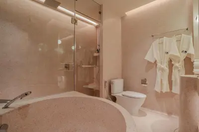a bathroom with a tub and a toilet and a shower at Inn a day in Bangkok