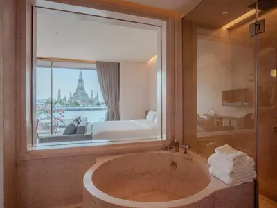 a bathroom with a large window and a tub at Inn a day in Bangkok