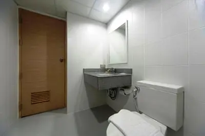 a bathroom with a toilet and a sink at Gateway Hotel Pratunam in Bangkok