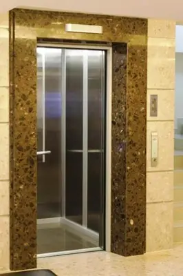 a mirror in a bathroom with a glass door at Gateway Hotel Pratunam in Bangkok