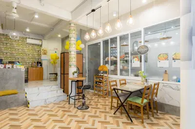 a restaurant with a table and chairs in a room at Lemon Siam Hostel Free Breakfast in Bangkok