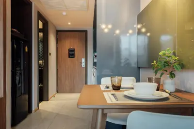 a kitchen with a wooden table with a plate on it at Montana Bangkok Hotel & Residence in Bangkok
