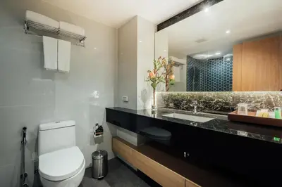 a bathroom with a toilet and a sink at Montana Bangkok Hotel & Residence in Bangkok