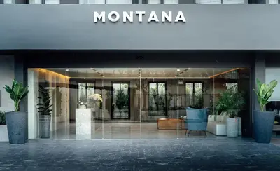 a building with a sign on the front of it at Montana Bangkok Hotel & Residence in Bangkok